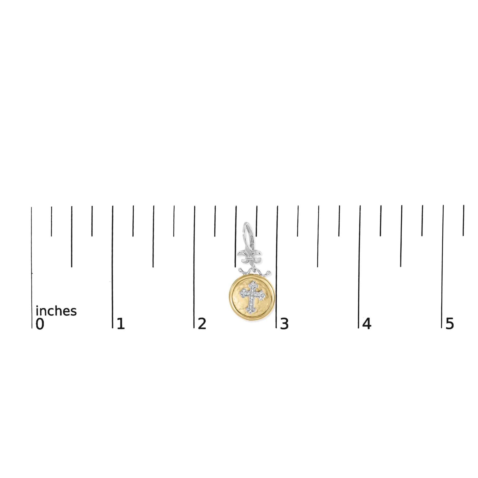 A pair of 18K yellow gold plated .925 sterling silver medallion earrings with cross drop and dangle design, displayed on a ruler for scale.