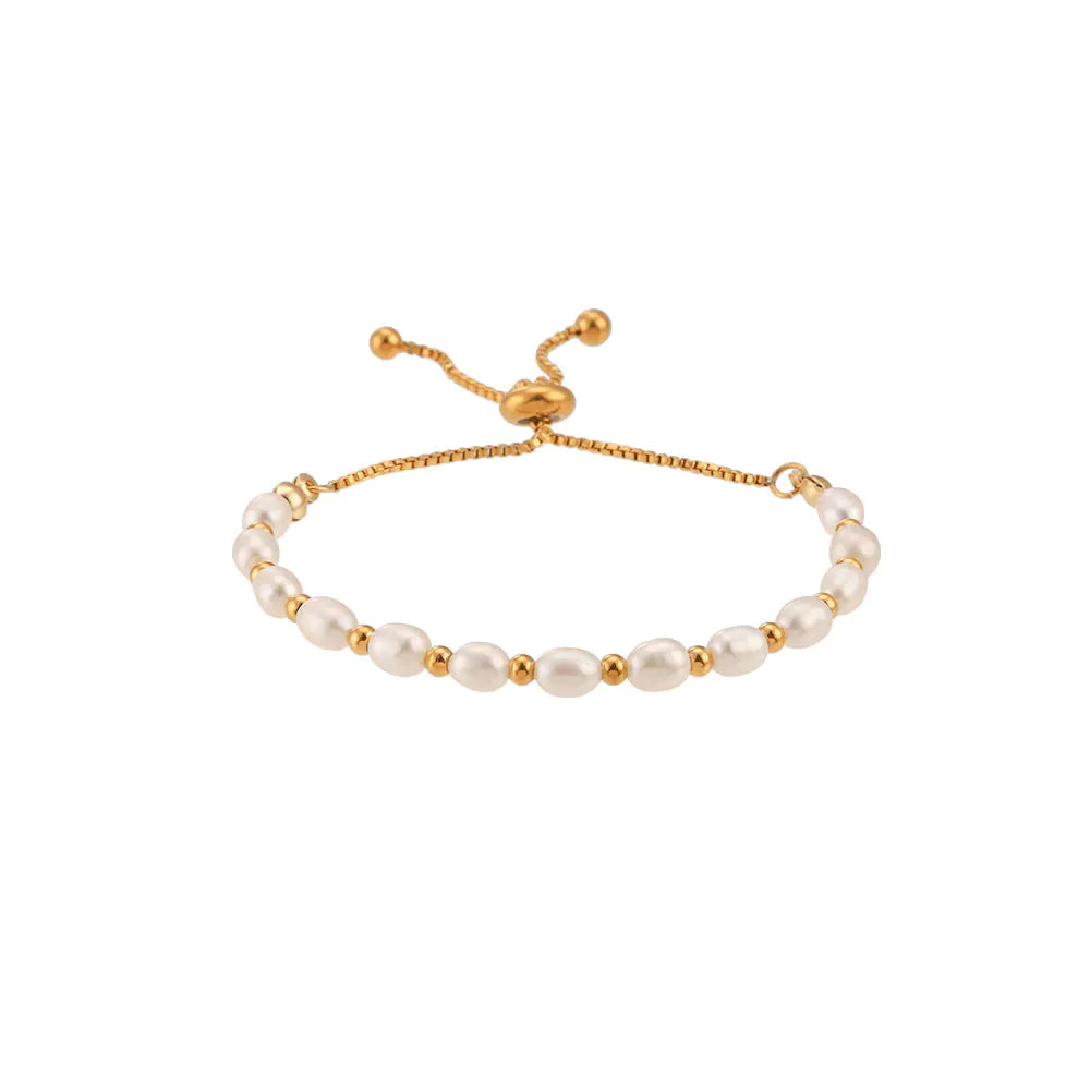 A gold-colored stainless steel drawstring bracelet with freshwater pearl spacer beads.