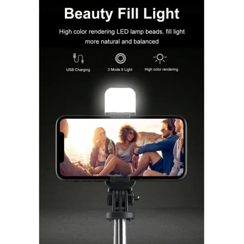 A 3-in-1 Bluetooth wireless selfie stick and tripod, with the device mounted on the tripod, displaying an image of a group of people on the smartphone screen.