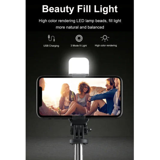 A 3-in-1 Bluetooth wireless selfie stick and tripod, with the device mounted on the tripod, displaying an image of a group of people on the smartphone screen.