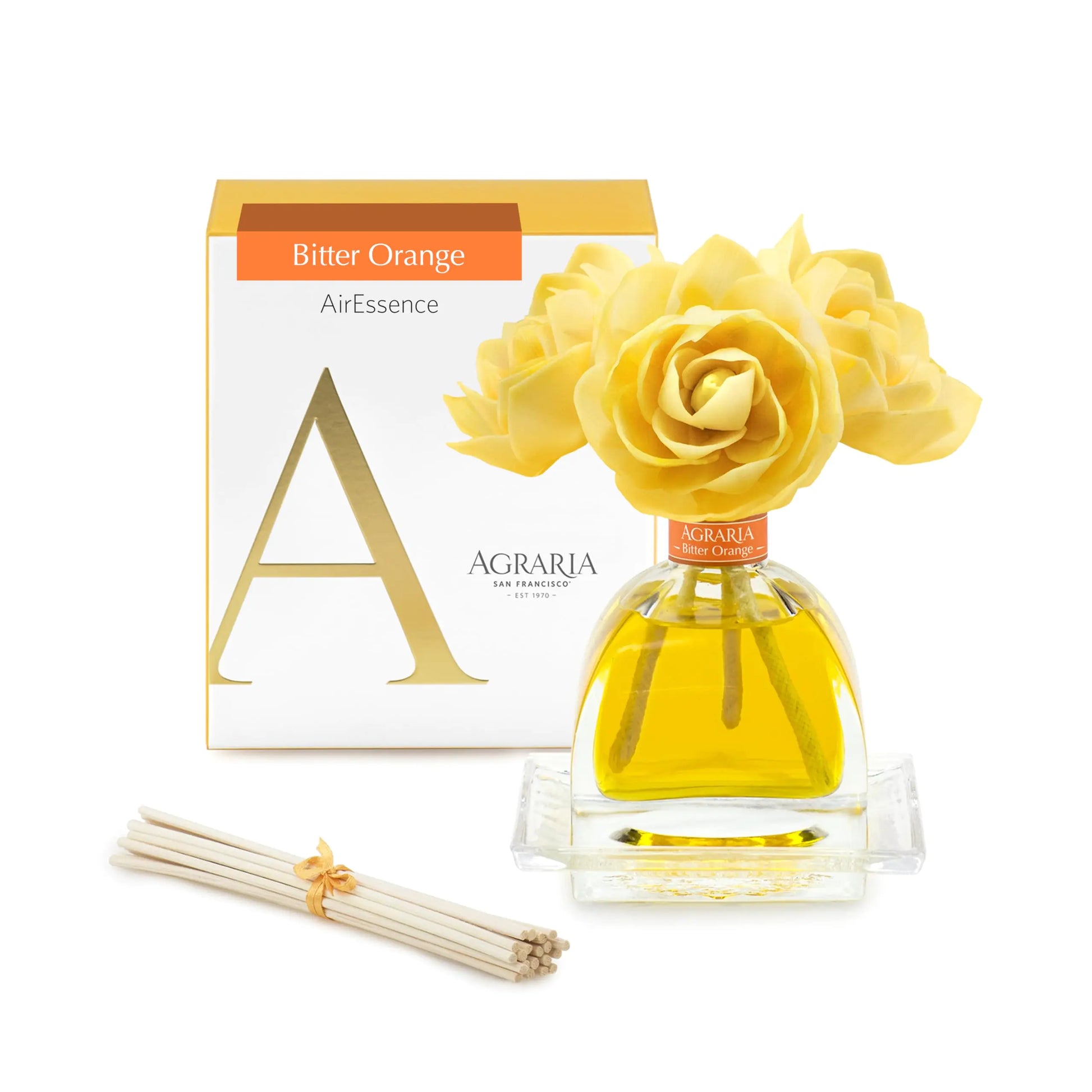 Agraria PetiteEssence room fragrance diffuser set with a handcrafted sola flower and reed sticks in a blue box decorated with red leaves and a red ribbon.