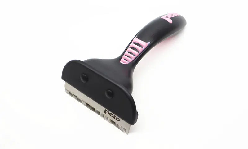 A pink cat grooming brush and de-shedding tool with a metal blade and plastic handle.