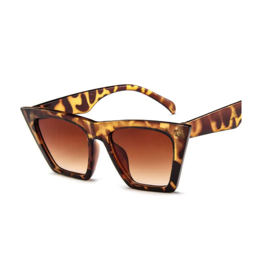 A pair of cat eye style sunglasses with a brown tortoiseshell pattern frame and lenses.