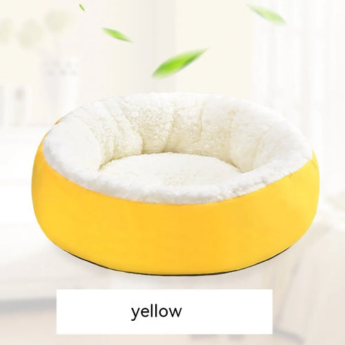 A round yellow pet bed made of lamb wool, designed for cats to provide warmth and comfort.
