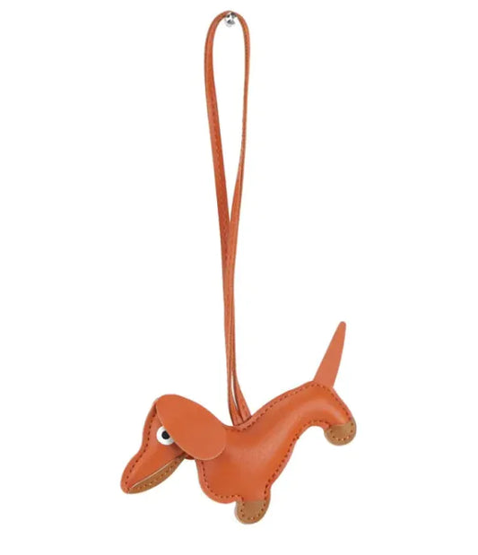 A orange miniature sausage-shaped keychain with a girly aesthetic, made from high-quality, soft material.
