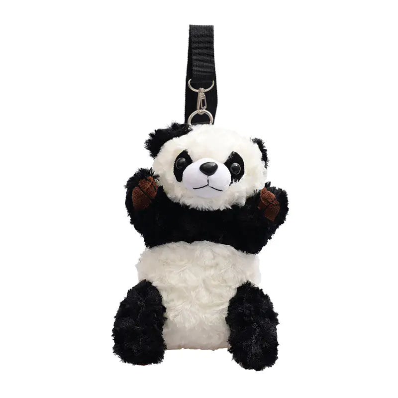 A plush shoulder bag designed to look like a panda with black and white colors, featuring a strap and a ring for carrying.