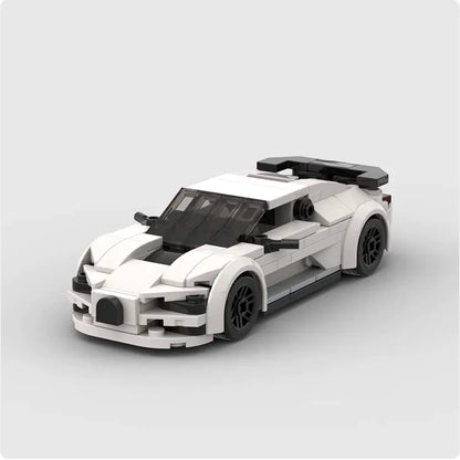 A white Bugatti Centodieci model car constructed from small black and white particle building blocks.