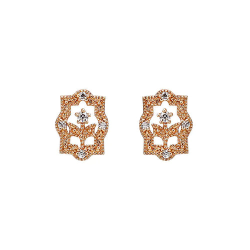 A pair of rose gold-colored earrings with a floral design and zircon embellishments.