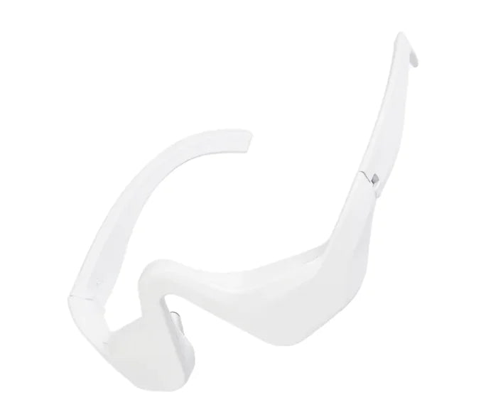A white, sleek eye bag remover device with a curved design for the under-eye area.