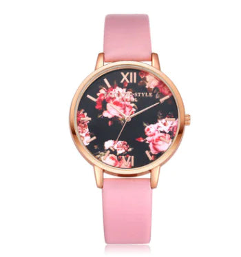 A rose gold watch with a floral dial and a pink PU strap.