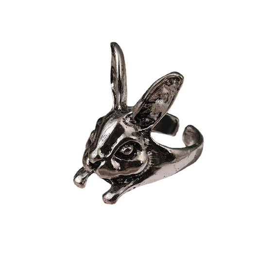 A silver-colored fashion ring designed in the shape of a rabbit's head, with detailed ears and eyes, on a white background.