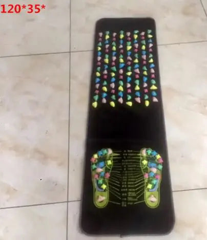 A foot massage fitness equipment with multicolored massage points, dimensions 175*35 cm, laid on a grey floor.