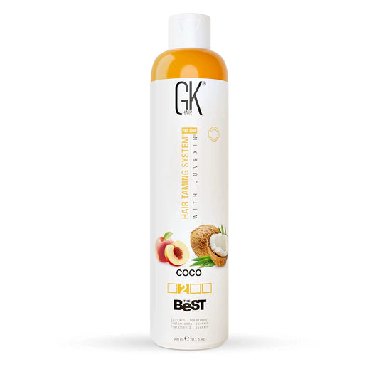 Bottle of GK HAIR Global Keratin The Best COCO smoothing keratin hair treatment with images of coconut and peach on the label.