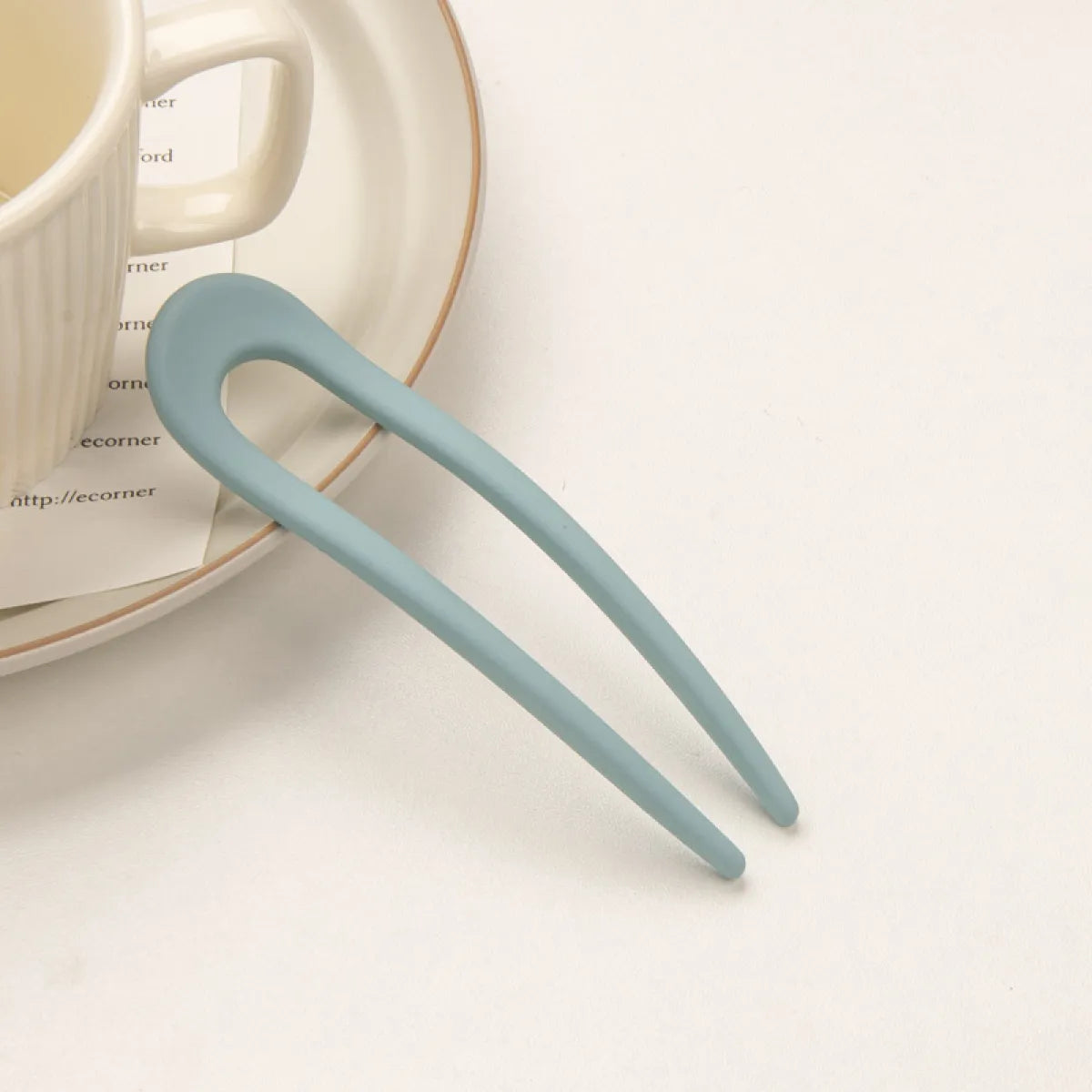 A pair of U-shaped hairpins in blue color, with dimensions 3 cm by 11.5 cm.