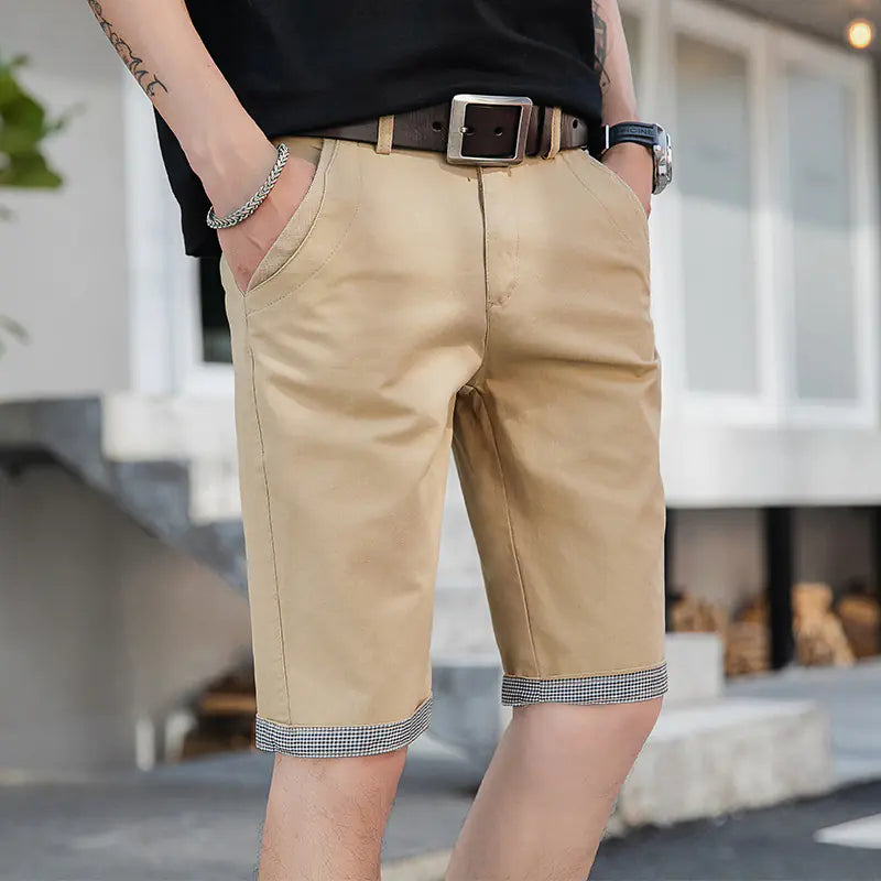 A pair of men's casual loose sports pants in khaki color with a tie cord closure, mid-waist, straight tube design, and a belt.