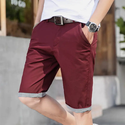 A pair of men's casual loose sports pants in khaki color with a tie cord closure, mid-waist, straight tube design, and a belt.