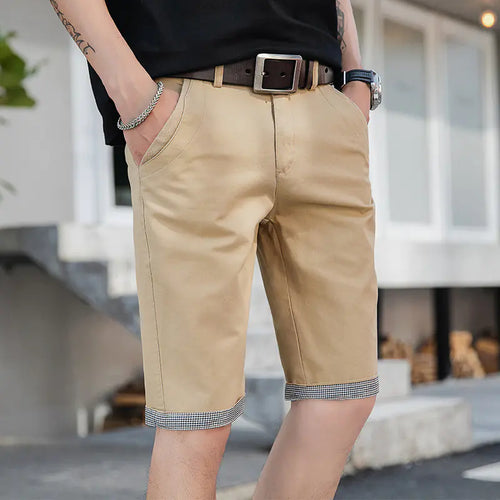 A pair of men's casual loose sports pants in khaki color with a tie cord closure, mid-waist, straight tube design, and a belt.