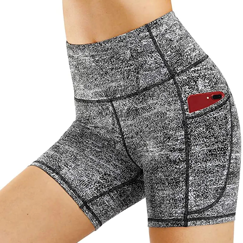 A pair of women's yoga fitness running shorts in a camouflage pattern with a phone pocket on the right side.