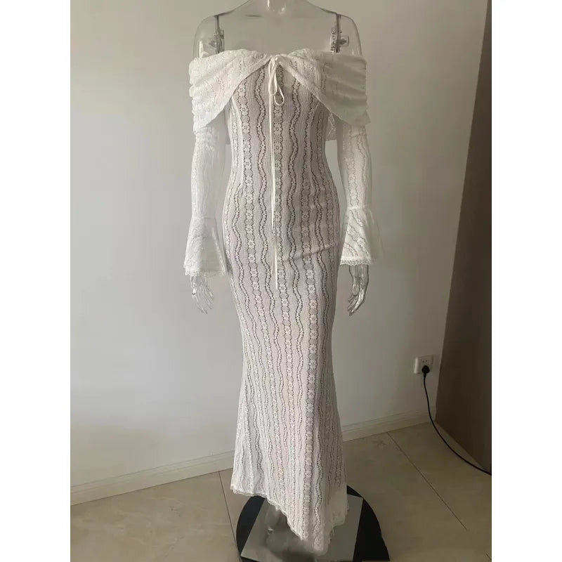 An off-shoulder white sheath dress with flared sleeves and lace details displayed on a mannequin.