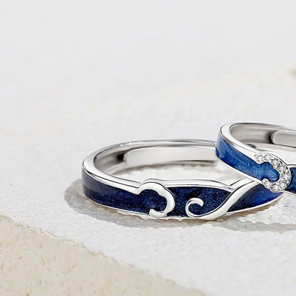 A sterling silver couple ring with a starry sky design, featuring blue enamel and a small diamond at the center.