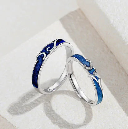 A sterling silver couple ring with a starry sky design, featuring blue enamel and a small diamond at the center.
