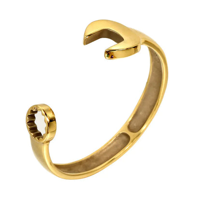 A gold-colored stainless steel wrench bracelet with a simple and modern design, displayed against a white background.