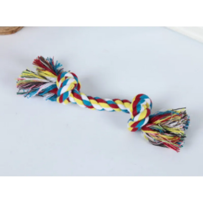 A multicolored cotton rope dog toy with knots and frayed ends, laid out on a white background.