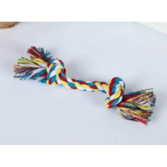 A multicolored cotton rope dog toy with knots and frayed ends, laid out on a white background.