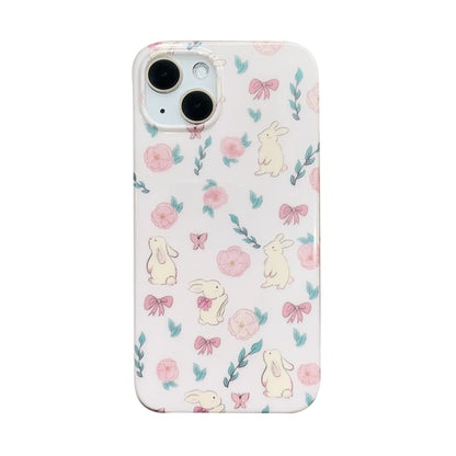 A white iPhone 15 case with a 3D floral and rabbit pattern designed for women and girls.
