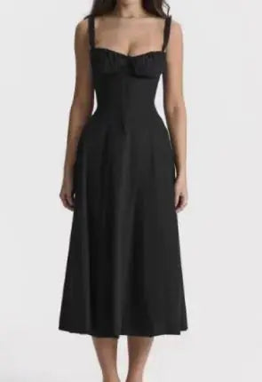 A woman modeling a sleeveless, high-waisted, floral print, A-line long skirt dress with straps.