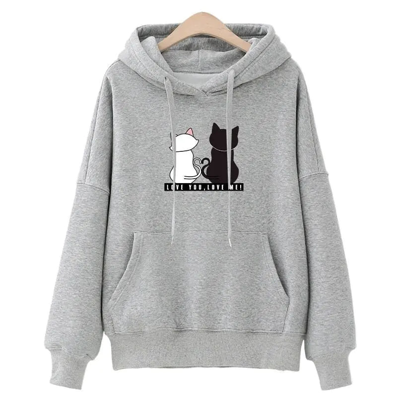 A pink hoodie with a graphic of a white cat and a black cat on the front, along with the text 'Korean style'.