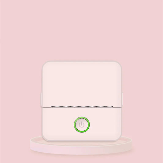 A compact portable thermal printer with a white body and a green power button, displayed against a pink background.