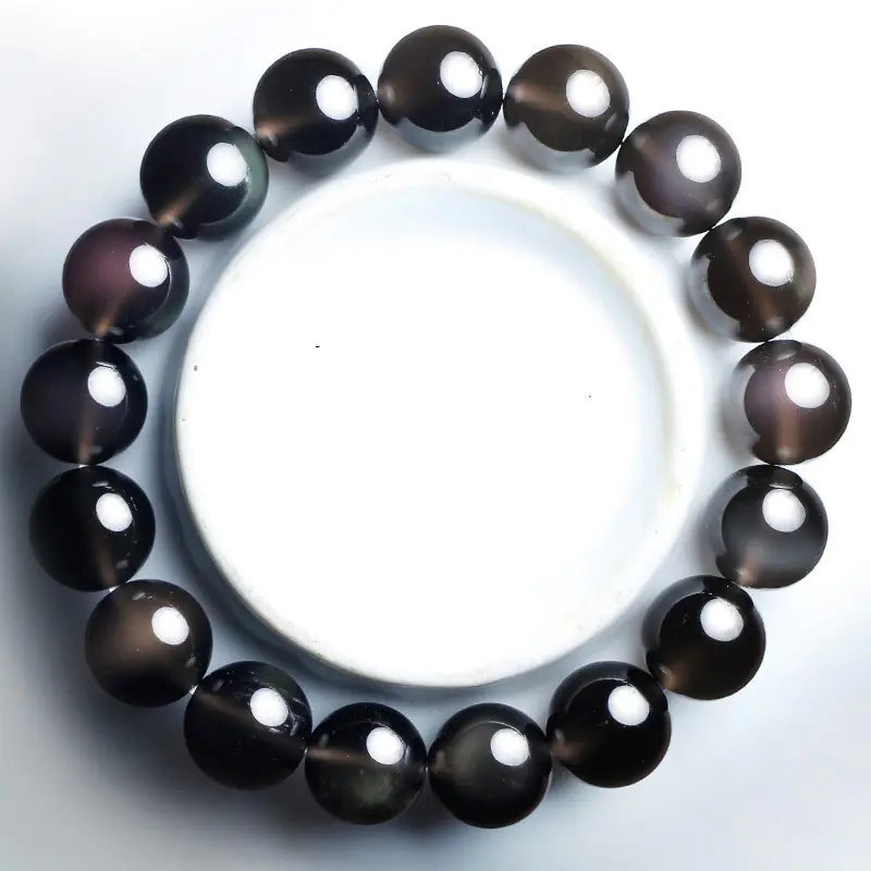 A black obsidian bracelet with a mystical PI Xiu symbol, designed for couples.