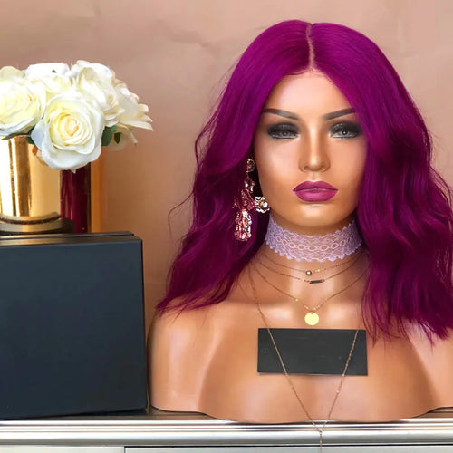 A mannequin head featuring a vibrant purple wig with a wavy hairstyle, displayed with accessories and makeup.