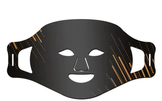 A black silicone face mask with cut-outs for the eyes and nose, featuring gold accents on the design.