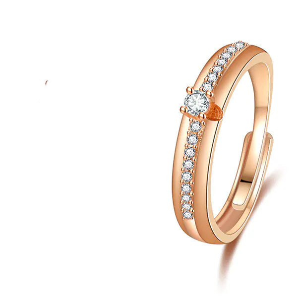 A set of two rings, one for men and one for women, with the men's ring featuring a simple band and the women's ring featuring a band with a central diamond and side accents.