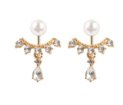 A pair of gold-colored hoop earrings with a matte frosted texture, featuring clear crystals and pearls.