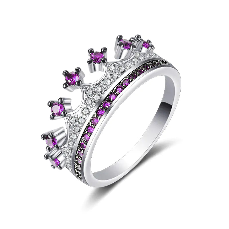 A two-tone heart-shaped zircon ring with gold-plated inlaid artificial gemstones on a white background.