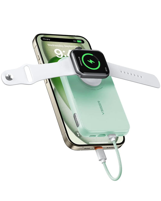 A portable green power bank with a built-in cable, displaying a white Apple Watch on top, and a smartphone connected to it via a USB cable.