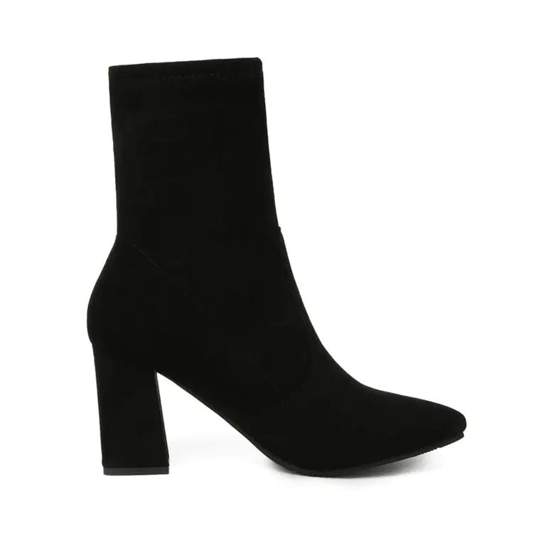 A black chunky heel ankle boot with a pointed toe and rubber sole.