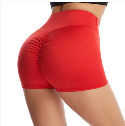 Side view of a person wearing red hip raise sports shorts.