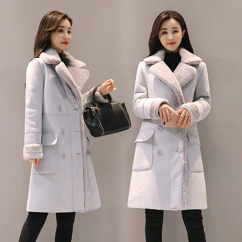 Two women modeling long lambswool coats in light gray and light pink colors, featuring a lapel collar and long sleeves.