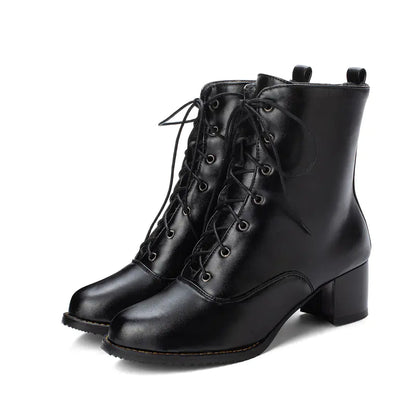 A pair of black mid-calf chunky heel Martin boots with lace-up front and round toe shape.