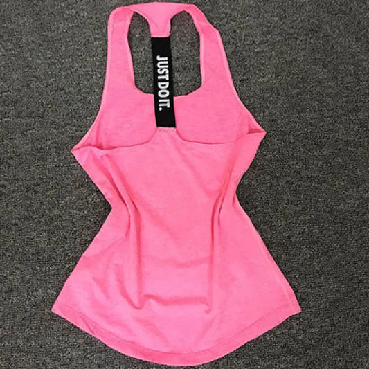 A pink women's running sports vest laid flat on a grey surface, showcasing the front view with a brand label that reads 'JUST DO IT'.