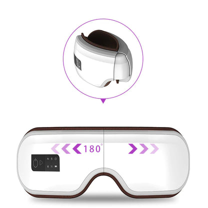 A white foldable smart eye massager with a battery compartment on the top and a blue light indicator. The device has a sleek, modern design with brown accents around the eyes.